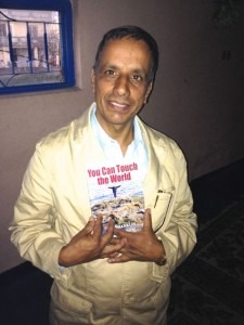 A Methodist pastor with the English version of You Can Touch the World.