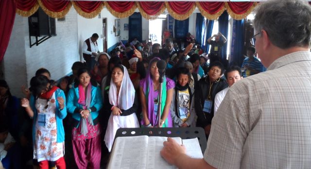 Tom leading an altar call in Nepal in November 2013.